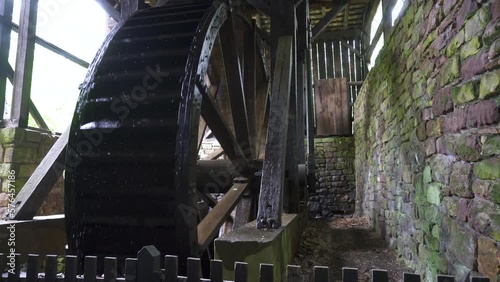 Hopewell Furnace National Historic Site in Pennsylvania. Hopewell's 22-foot diameter waterwheel catches a flow of water from French Creek to power the furnace's air blast machinery. photo