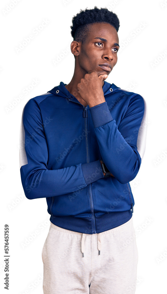 Young african american man wearing sportswear with hand on chin thinking about question, pensive expression. smiling with thoughtful face. doubt concept. Young african american man wearing sportswear with hand on chin thinking about question, pensive expression. smiling with thoughtful face. doubt concept.