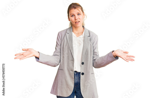 Young beautiful blonde woman wearing elegant jacket clueless and confused with open arms, no idea concept.