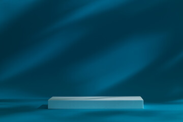 Dark moody podium stage for products or cosmetics against dark blue background and leaves shadows on the wall.	
