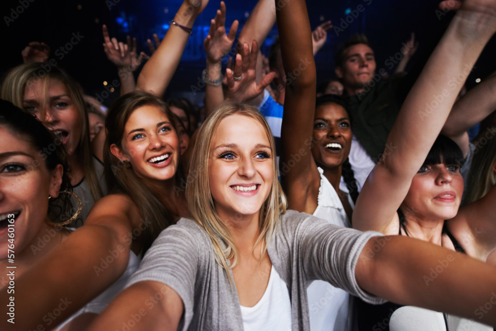 Attractive female fans enjoying a concert- This concert was created for the sole purpose of this photo shoot, featuring 300 models and 3 live bands. All people in this shoot are model released - obrazy, fototapety, plakaty 
