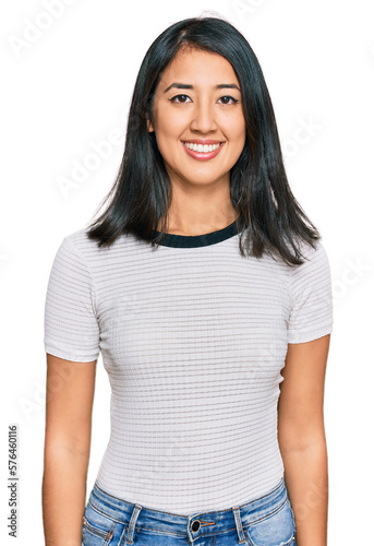 Beautiful asian young woman wearing casual white t shirt with a happy and cool smile on face. lucky person.
