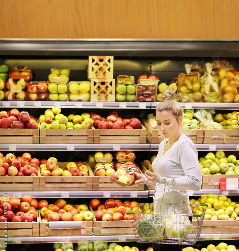 Woman buying fruits and vegetables at the market