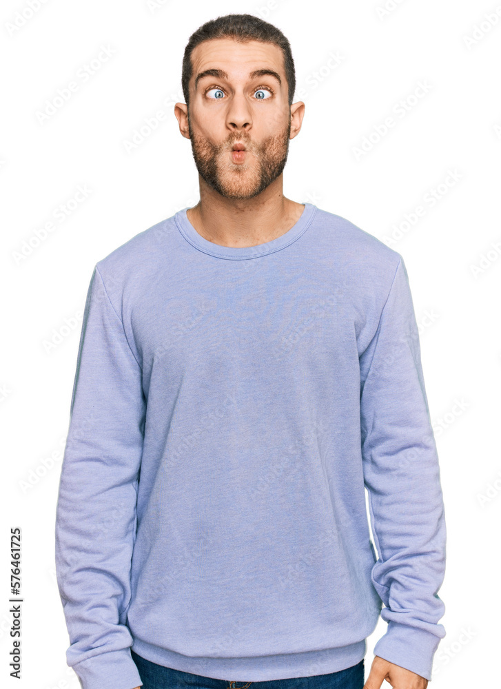 Young caucasian man wearing casual clothes making fish face with lips, crazy and comical gesture. funny expression. Young caucasian man wearing casual clothes making fish face with lips, crazy and comical gesture. funny expression.