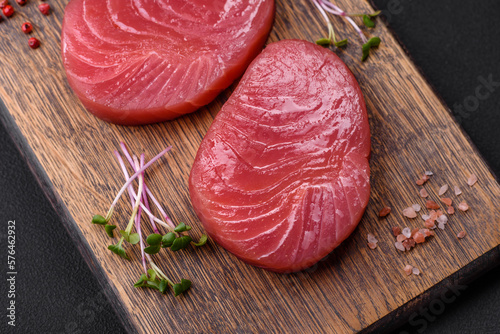 Two fresh slices of raw tuna fillet with spices and herbs