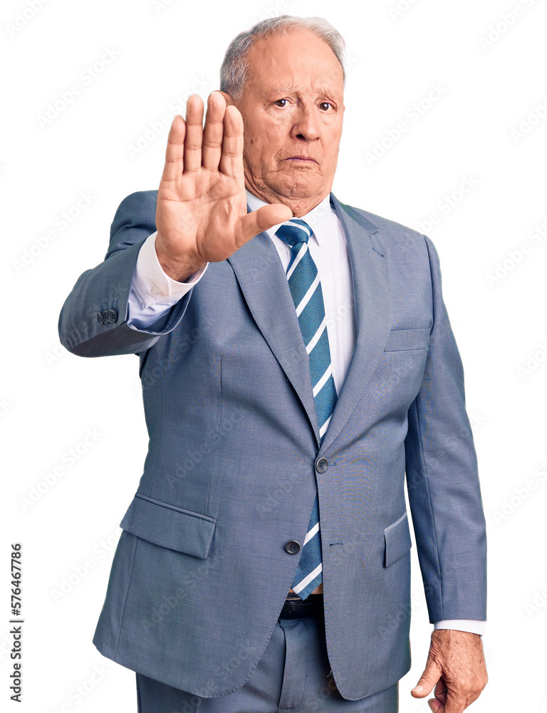 Senior handsome grey-haired man wearing elegant suit doing stop sing with palm of the hand. warning expression with negative and serious gesture on the face. Senior handsome grey-haired man wearing elegant suit doing stop sing with palm of the hand. warning expression with negative and serious gesture on the face.