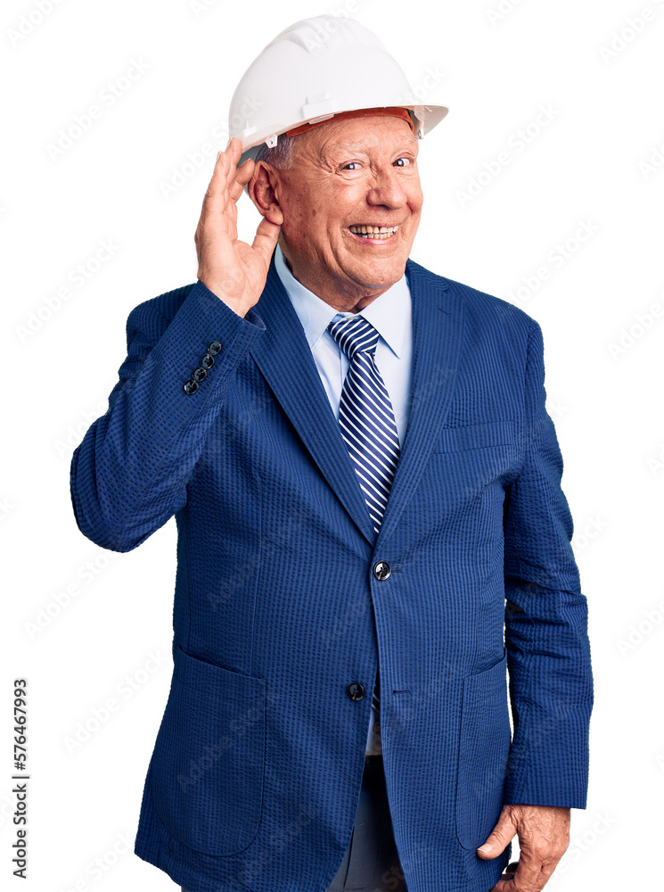 Senior handsome grey-haired man wearing suit and architect hardhat smiling with hand over ear listening an hearing to rumor or gossip. deafness concept. Senior handsome grey-haired man wearing suit and architect hardhat smiling with hand over ear listening an hearing to rumor or gossip. deafness concept.