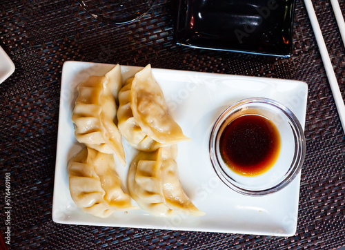 Image of Japanese tasty dumplings gyozas with soy sauce, nobody photo