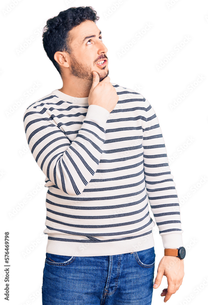 Young hispanic man wearing casual clothes thinking worried about a question, concerned and nervous with hand on chin Young hispanic man wearing casual clothes thinking worried about a question, concerned and nervous with hand on chin