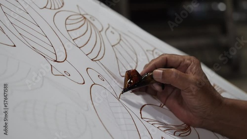 Making batik tulis Solo.  The technique of making batik by writing using a canting tool. Canting consists of nyamplung, cucuk, gagang or handles made of copper, bamboo and wax photo