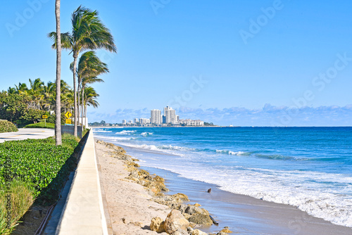 Blue ocean and palm tree views along the Atlantic coastline in West Palm Beach in Palm Beach County  Florida.  