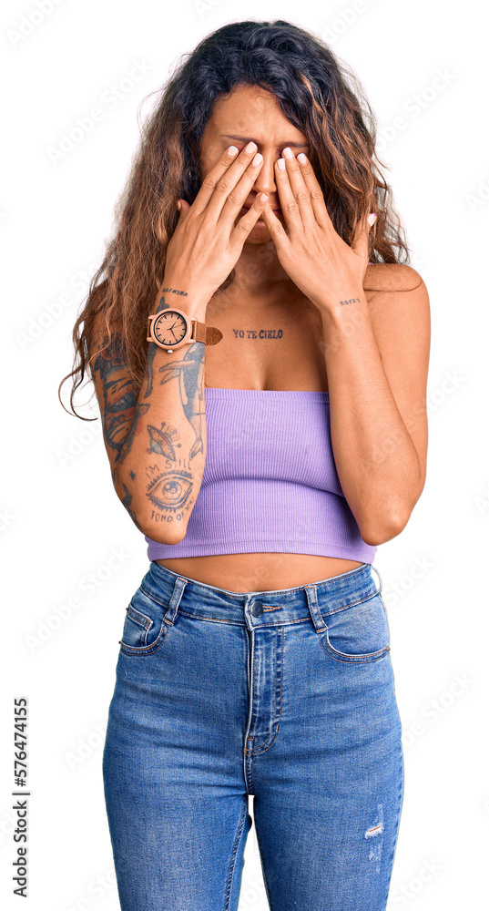 Young hispanic woman with tattoo wearing casual clothes rubbing eyes for fatigue and headache, sleepy and tired expression. vision problem Young hispanic woman with tattoo wearing casual clothes rubbing eyes for fatigue and headache, sleepy and tired expression. vision problem