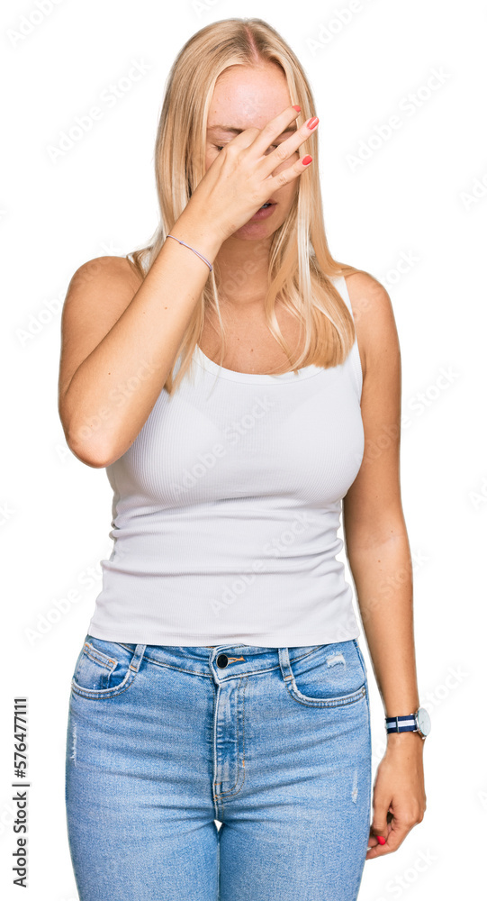 Young blonde girl wearing casual style with sleeveless shirt tired rubbing nose and eyes feeling fatigue and headache. stress and frustration concept. Young blonde girl wearing casual style with sleeveless shirt tired rubbing nose and eyes feeling fatigue and headache. stress and frustration concept.