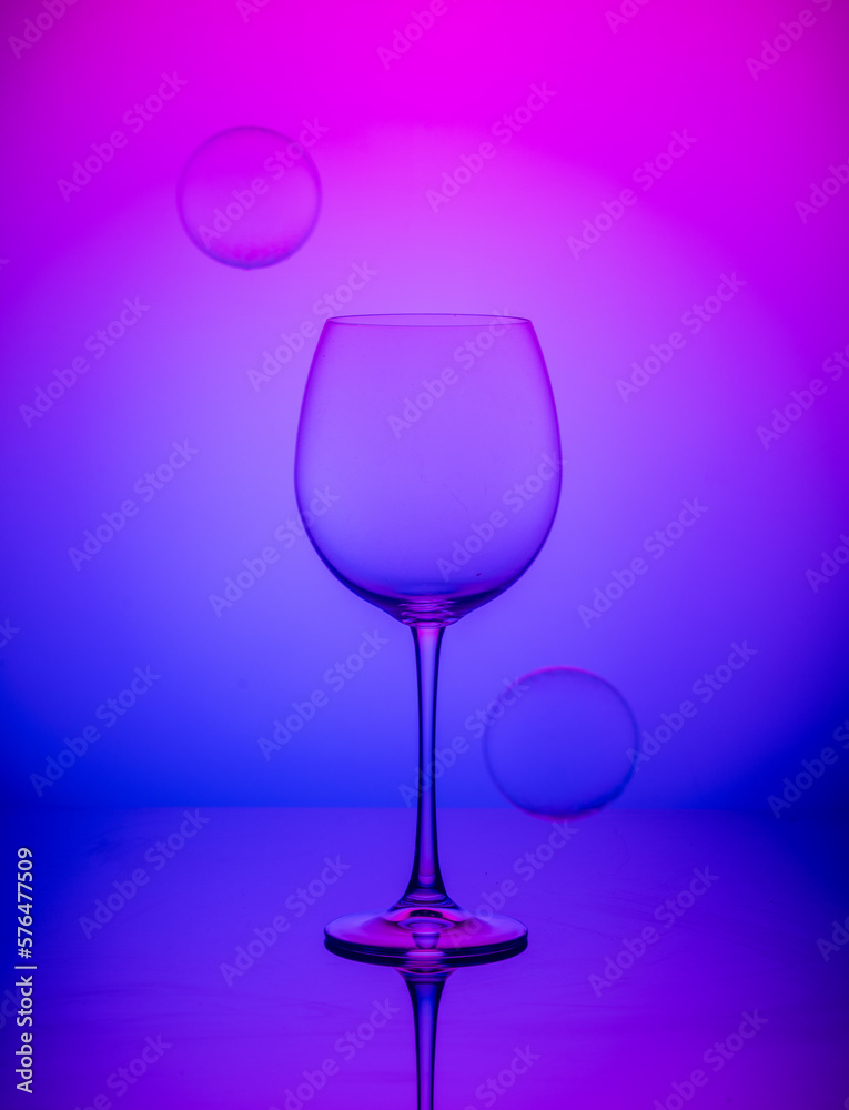 wine glass with balls on a blue-pink background