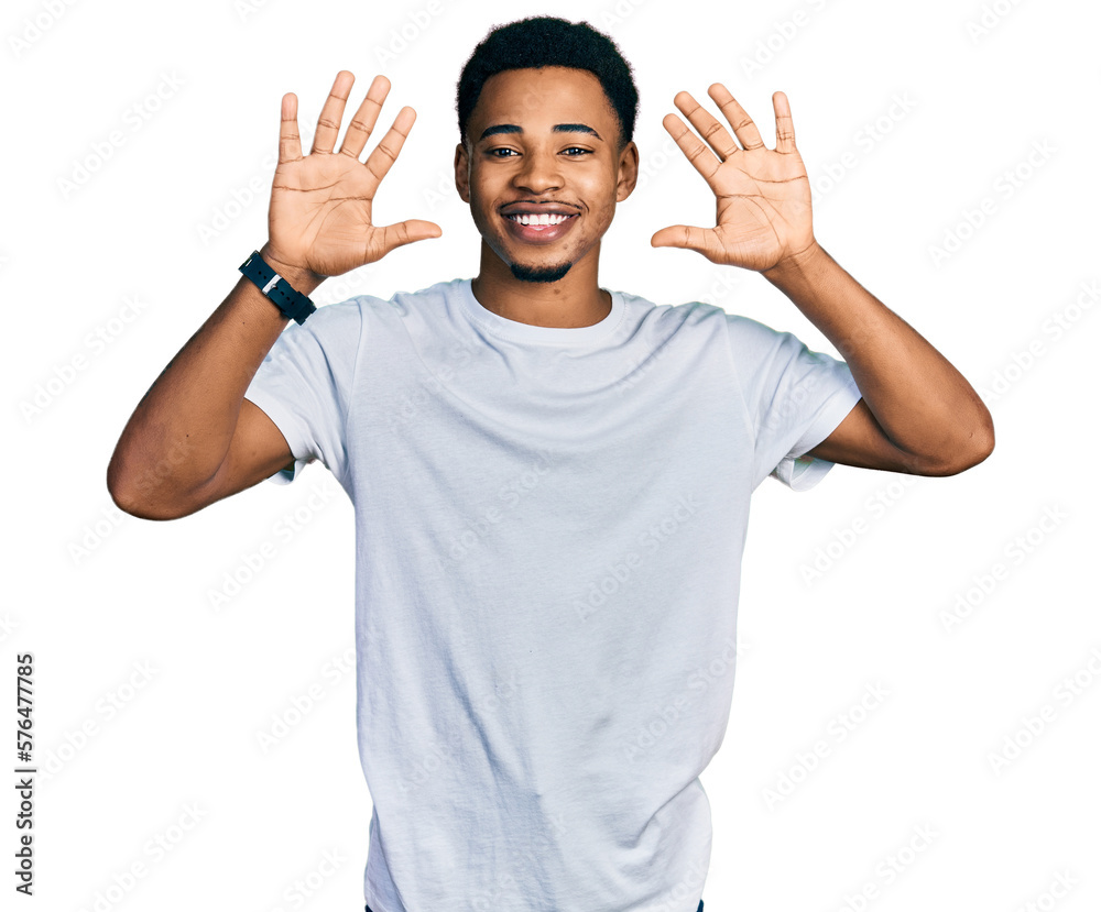 Young african american man wearing casual white t shirt showing and pointing up with fingers number ten while smiling confident and happy. Young african american man wearing casual white t shirt showing and pointing up with fingers number ten while smiling confident and happy.