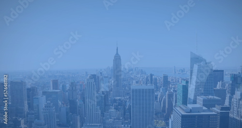 Image of modern cityscape over blue background
