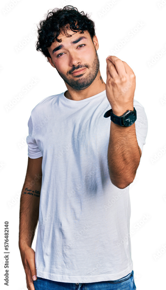Hispanic young man with beard wearing casual white t shirt doing italian gesture with hand and fingers confident expression Hispanic young man with beard wearing casual white t shirt doing italian gesture with hand and fingers confident expression