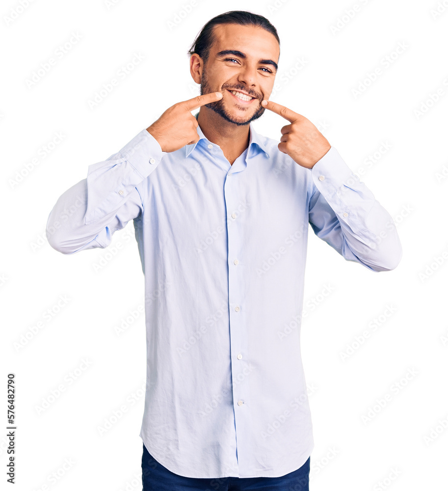 Young handsome man wearing business clothes smiling cheerful showing and pointing with fingers teeth and mouth. dental health concept. Young handsome man wearing business clothes smiling cheerful showing and pointing with fingers teeth and mouth. dental health concept.