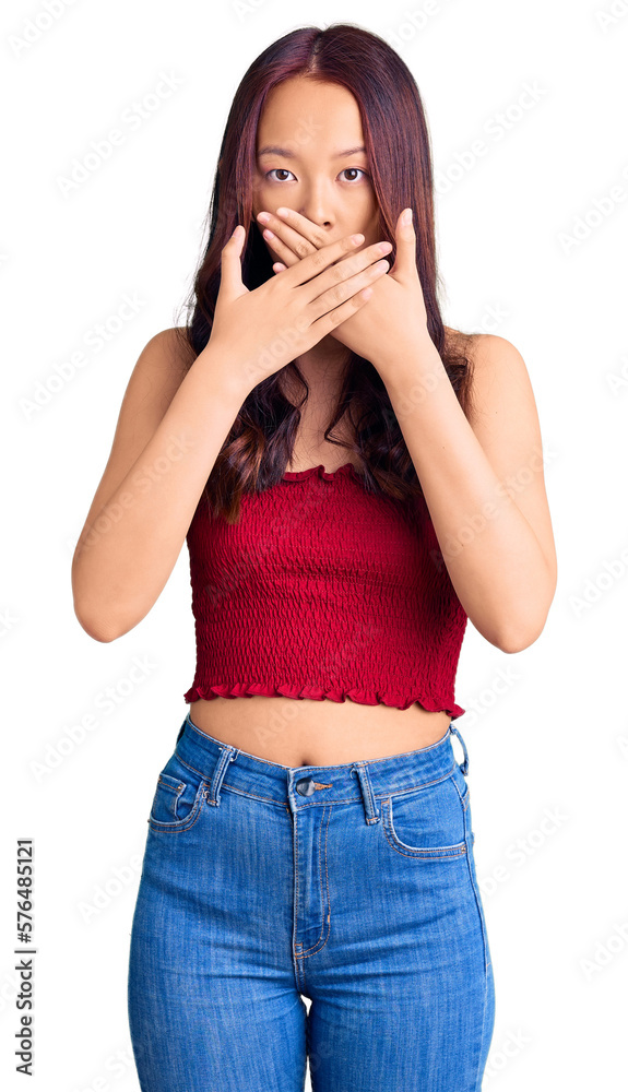 Young beautiful chinese girl wearing casual clothes shocked covering mouth with hands for mistake. secret concept. Young beautiful chinese girl wearing casual clothes shocked covering mouth with hands for mistake. secret concept.