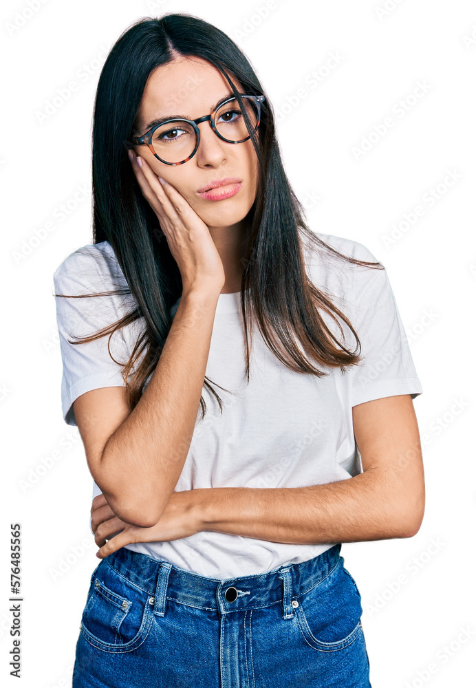 Young hispanic woman wearing casual clothes and glasses thinking looking tired and bored with depression problems with crossed arms. Young hispanic woman wearing casual clothes and glasses thinking looking tired and bored with depression problems with crossed arms.