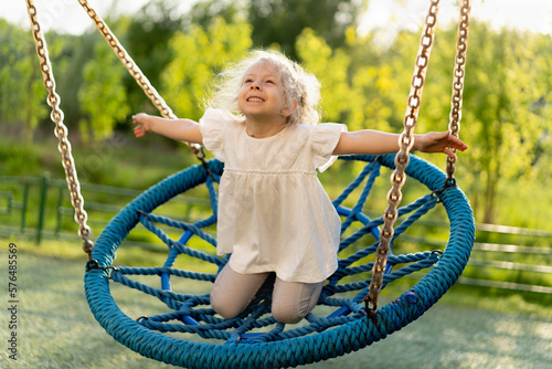 happy little girl on a big swing