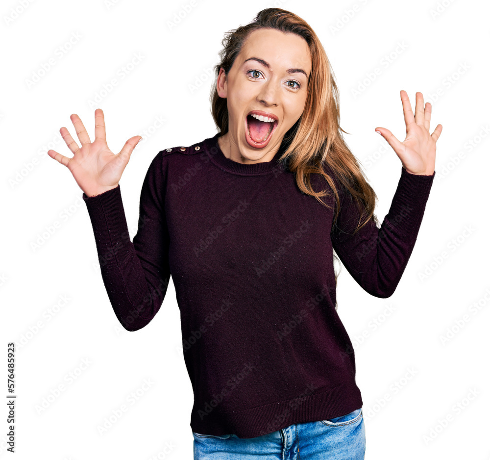 Young caucasian woman wearing casual clothes celebrating crazy and amazed for success with arms raised and open eyes screaming excited. winner concept Young caucasian woman wearing casual clothes celebrating crazy and amazed for success with arms raised and open eyes screaming excited. winner concept