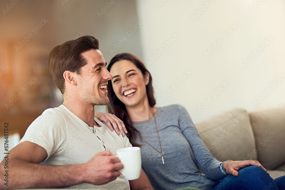 Filling their home with love and laughter. Shot of a happy young couple relaxing together at home. Filling their home with love and laughter. Shot of a happy young couple relaxing together at home.
