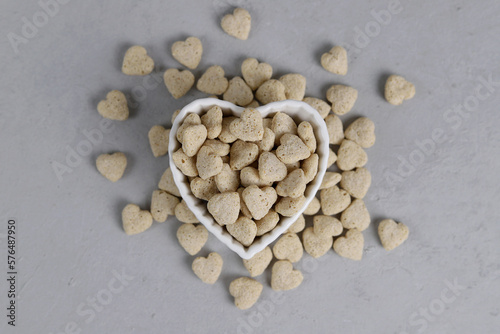 Top view of bran in a bowl with a heart shape on a gray background. Bran in the shape of a heart. Healthy eating
