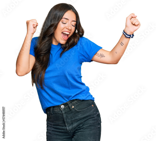 Beautiful brunette young woman wearing casual clothes dancing happy and cheerful, smiling moving casual and confident listening to music