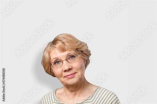 Elderly senior woman posing on background
