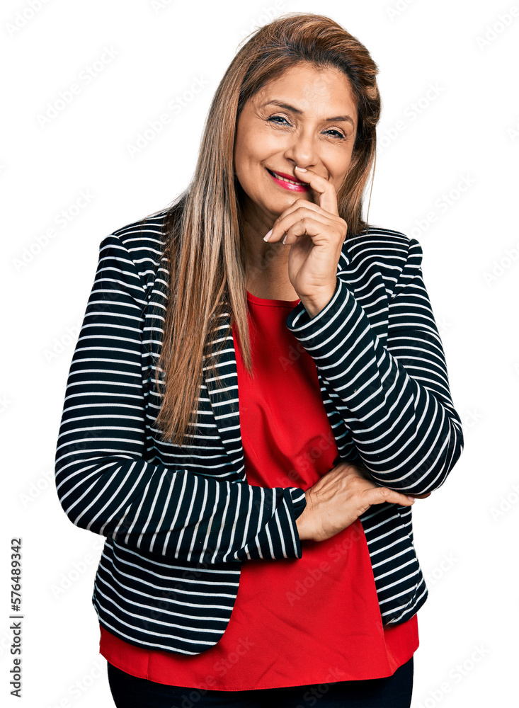 Middle age latin woman wearing business jacket smiling looking confident at the camera with crossed arms and hand on chin. thinking positive.