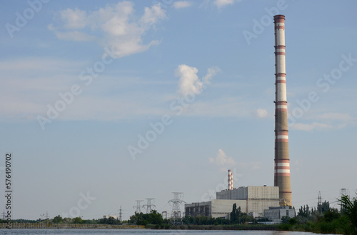 CHP building, power lines and a tall chimney. air emissions and air pollution. abandonment of thermal power plants in favor of the environment, transition to green energy