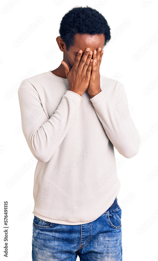 African handsome man wearing casual winter sweater with sad expression covering face with hands while crying. depression concept. African handsome man wearing casual winter sweater with sad expression covering face with hands while crying. depression concept.