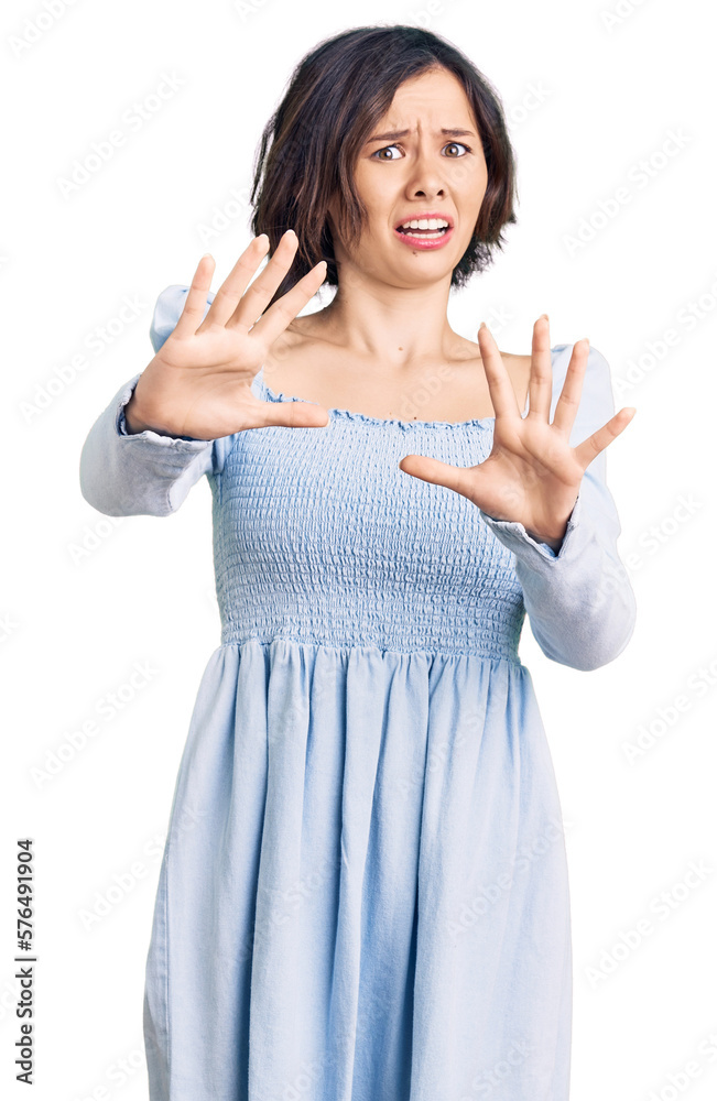 Young beautiful girl wearing casual clothes afraid and terrified with fear expression stop gesture with hands, shouting in shock. panic concept. Young beautiful girl wearing casual clothes afraid and terrified with fear expression stop gesture with hands, shouting in shock. panic concept.