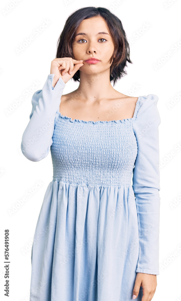 Young beautiful girl wearing casual clothes mouth and lips shut as zip with fingers. secret and silent, taboo talking Young beautiful girl wearing casual clothes mouth and lips shut as zip with fingers. secret and silent, taboo talking