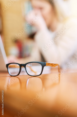 Your vision should be as clear as your future. Shot of a pair of glasses on a table indoors.