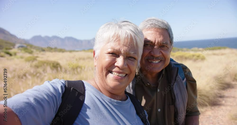 Portrait of happy senior biracial couple in mountains embracing, in slow motion Portrait of happy senior biracial couple in mountains embracing, in slow motion