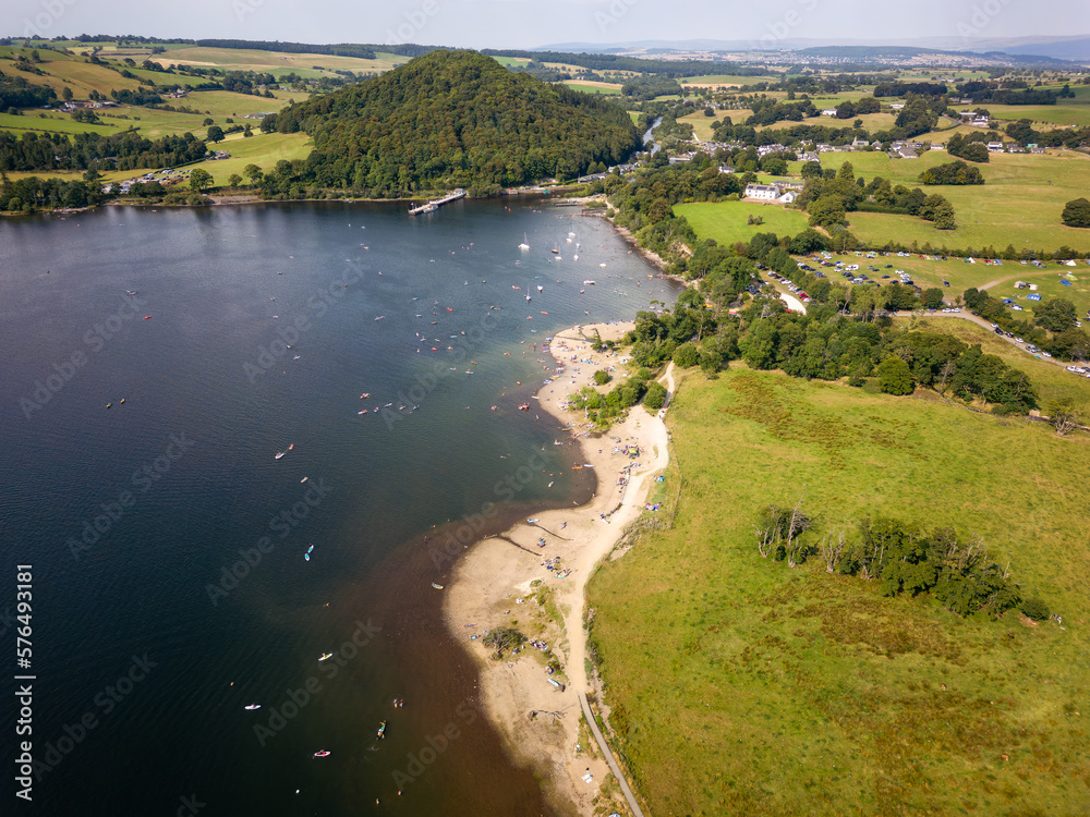Aerial view of a crowded beach on the shore of a large lake in summer (Ullswater, Lake District, England)