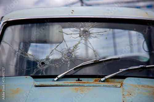 Bullet holes on windshield old car