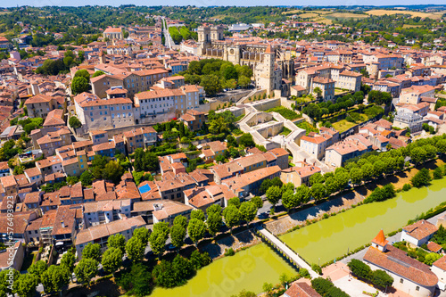 Picturesque summer landscape of French city of Auch on bank of River Gers overlooking Roman Catholic Cathedral and Armagnac Tower..
