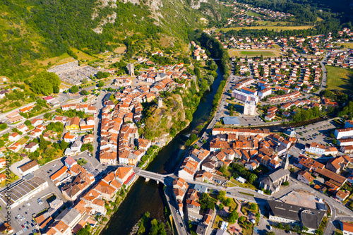 General aerial view of small French town of Tarascon-sur-Ariege in valley of Pyrenees on banks of Ariege river on summer day