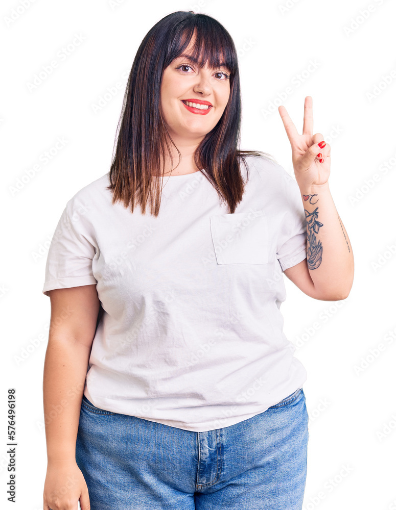 Young plus size woman wearing casual clothes gesturing with hands showing  big and large size sign, measure symbol. smiling looking at the camera.  meas Stock Photo - Alamy