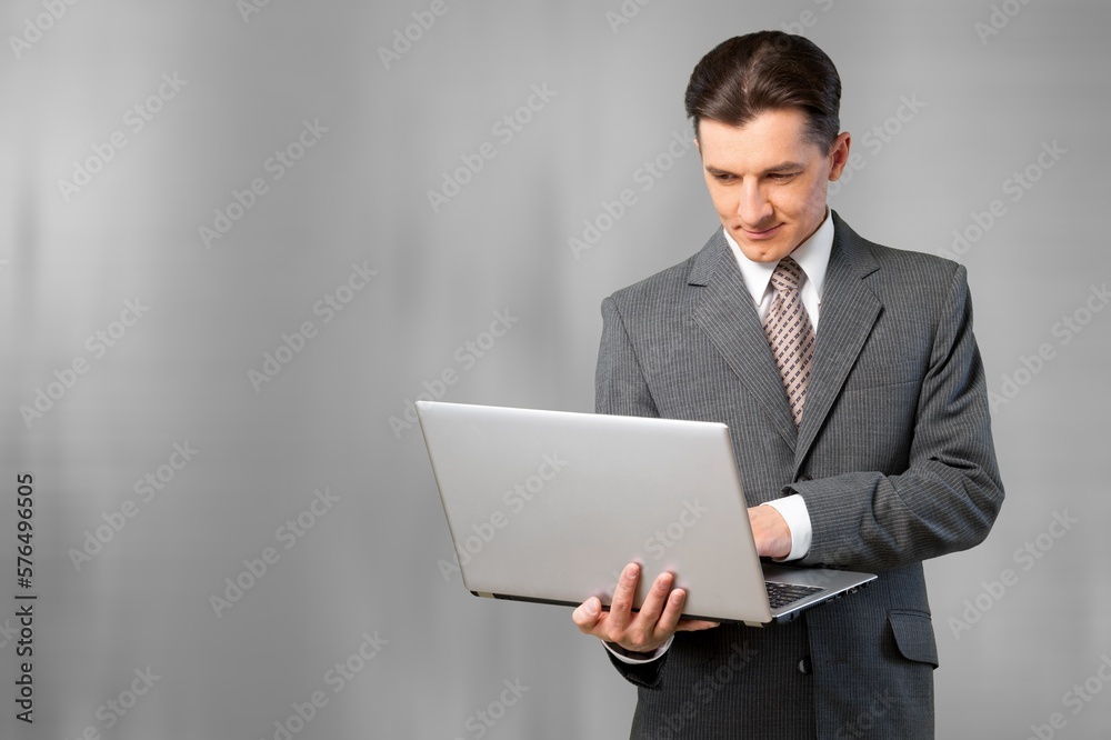 Happy young business man with laptop computer Happy young business man with laptop computer