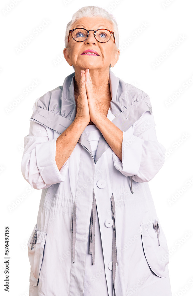 Senior beautiful woman with blue eyes and grey hair wearing casual clothes and glasses begging and praying with hands together with hope expression on face very emotional and worried. begging. Senior beautiful woman with blue eyes and grey hair wearing casual clothes and glasses begging and praying with hands together with hope expression on face very emotional and worried. begging.