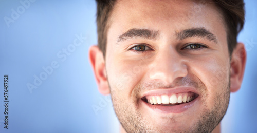 Happy, smile and portrait of a man doctor or nurse with confidence standing by mockup space. Happiness, headshot and face of professional male healthcare worker or surgeon in a medical clinic.
