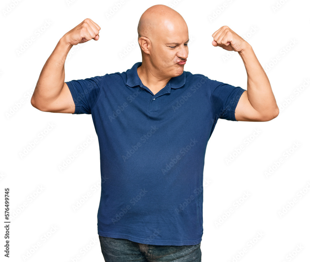 Middle age bald man wearing casual clothes showing arms muscles smiling proud. fitness concept. Middle age bald man wearing casual clothes showing arms muscles smiling proud. fitness concept.