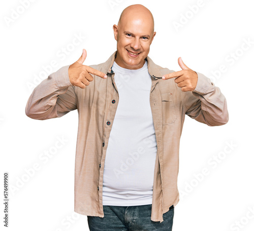 Middle age bald man wearing casual clothes looking confident with smile on face, pointing oneself with fingers proud and happy.