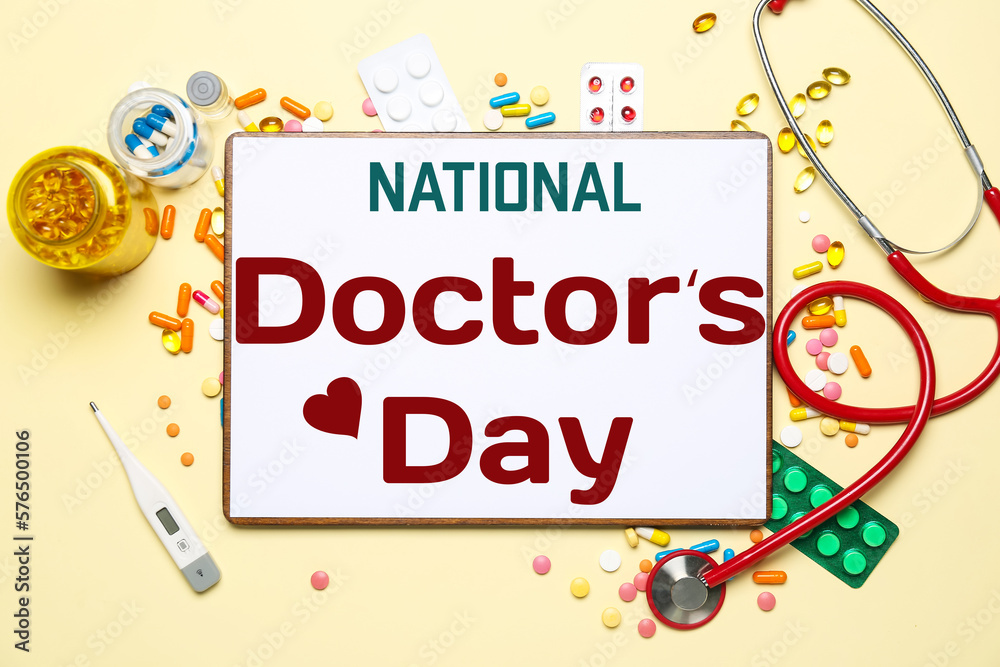 Paper with text NATIONAL DOCTORS DAY, stethoscope and drugs on beige background Paper with text NATIONAL DOCTORS DAY, stethoscope and drugs on beige background