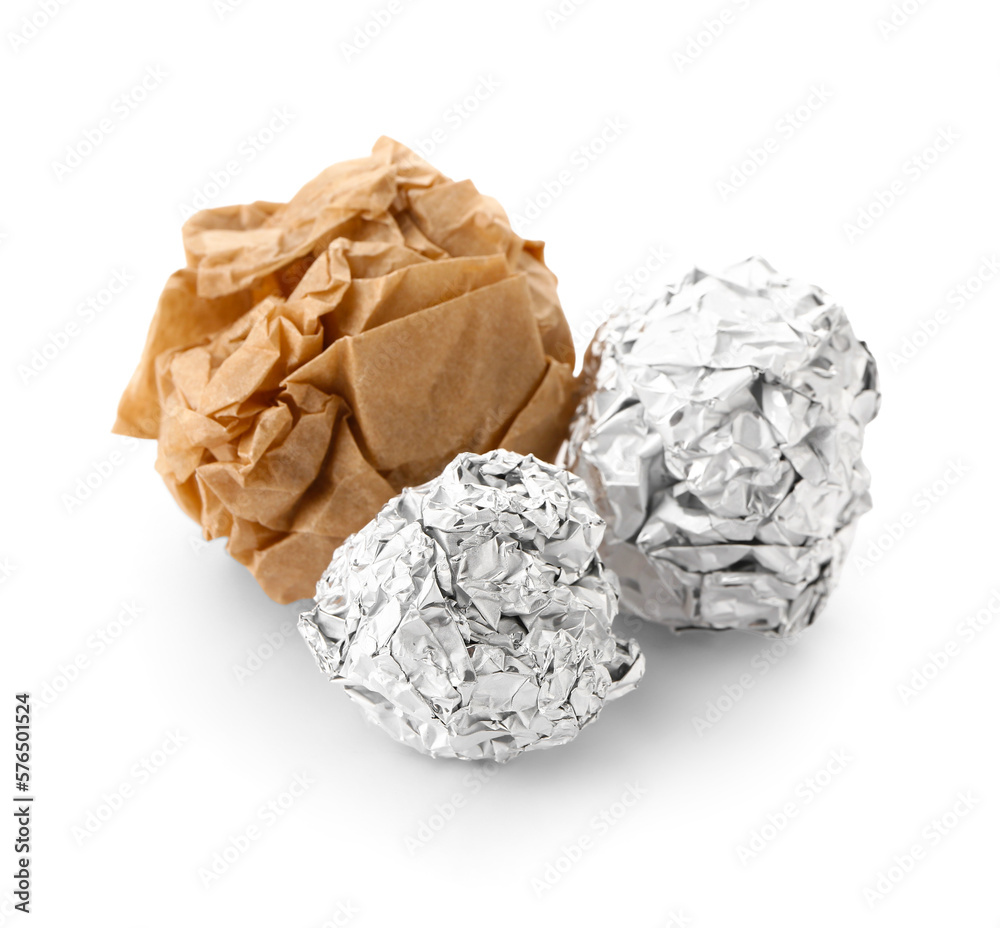 Crumpled balls of aluminium foil and baking paper on white background Crumpled balls of aluminium foil and baking paper on white background