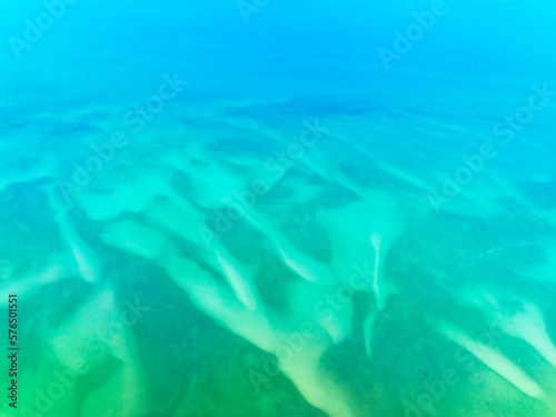 Top view Sea surface aerial view,Bird eye view photo of turquoise waves and water surface texture, Blue sea background, Beautiful waves nature, Amazing view seascape © panya99